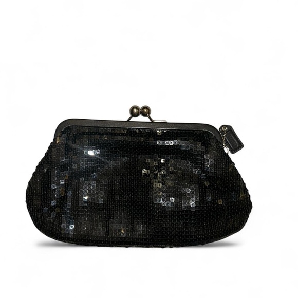 Coach black sequin kiss lock clutch
Limited Edition “Julia” collection